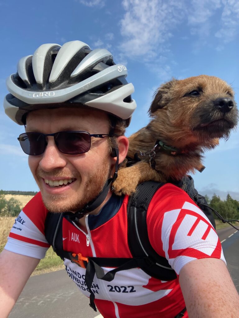 Cyclist with dog in backpack